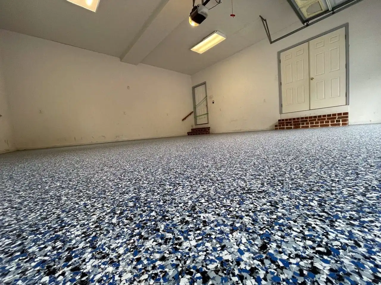 Blue, white, and black flake epoxy floor installed in a residential garage in West Richland, WA