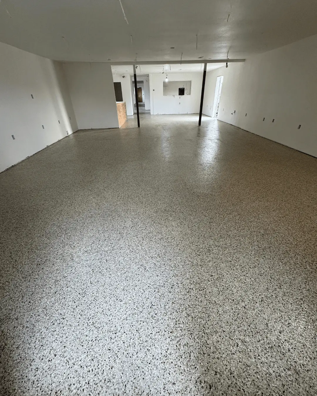 Large open commercial floor with neutral flake epoxy installed by Pure Reflection